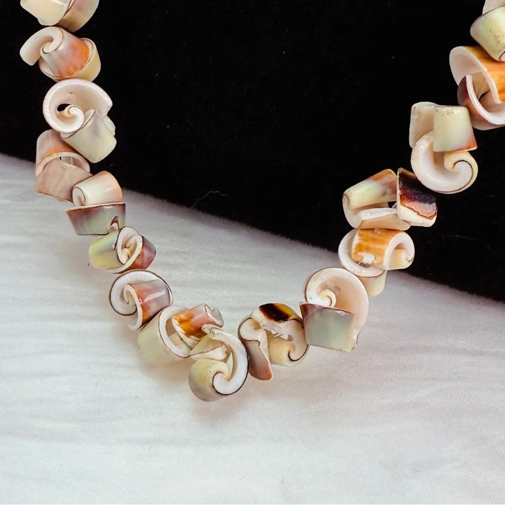 Beautiful vintage necklace composed of curly-cut conch shell beads individually